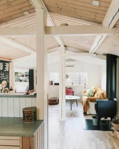a living room with a couch and a table at Moments In Relaxed Family House Near Kulhuse in Jægerspris