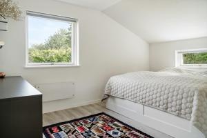 a bedroom with a bed and a window at Beautiful Tranquil Home By Fjord Near Copenhagen in Holbæk