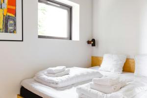 two white towels sitting on a bed in a room at Experience Majestic Nature On Helnæs in Ebberup