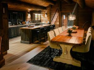 a kitchen with a wooden table in a cabin at Log Cabin With Views Over Turufjell in Flå +18 photos