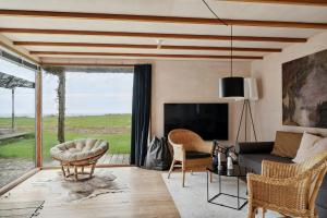 a living room with a couch and a tv at Family Time At Sea Air Nature By Ebeltoft Bay in Ebeltoft