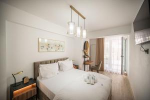 a bedroom with a white bed and a window at Ambient in Infinity Pool & Spa Resort in Mamaia