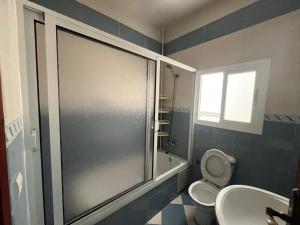 a bathroom with a shower and a toilet and a sink at Belle maison au cœur de Tanger in Tangier +11 photos