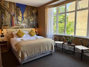 a bedroom with a bed and a large window at The Crescent Guest House in York