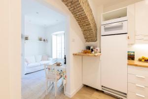 a kitchen with a white refrigerator and a table at Center Boutique in Cagliari +48 photos