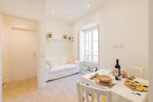 a living room with a table and a couch at Center Boutique in Cagliari