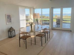 a dining room with a table and chairs with a view at Live By Isefjorden In A Home With A View in Skibby