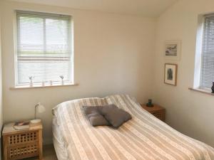 a bedroom with a bed with a pillow on it at Live By Isefjorden In A Home With A View in Skibby +14 photos