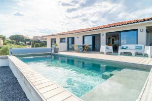 eine Villa mit Swimmingpool und ein Haus in der Unterkunft Villa With Panoramic Views Of Thau Lagoon in Bouzigues