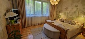 a bedroom with a large bed and a window at Apartament nad Jeziorem Necko in Augustów