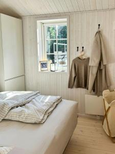 a bedroom with a bed and a window at Family Holiday Home Near Denmark's Best Beach in Væggerløse