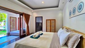 Postel nebo postele na pokoji v ubytování Kies Villas Lombok