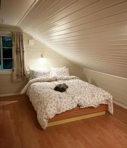 a bed with a stuffed animal on it in a bedroom at Cosy Cabin On Jetty In Lofoten in Skrova