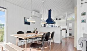 a kitchen and dining room with a table and chairs at Cottage By Kolding Fjord With Panoramic View in Kolding