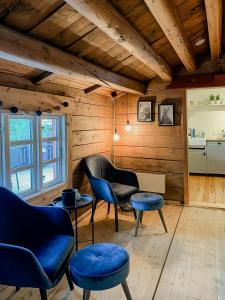 a living room with blue chairs and a table at Traditional Charm And Modern Style In Vågå in Vågåmo