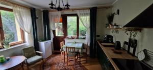 a kitchen with a table and a dining room at Apartament nad Jeziorem Necko in Augustów