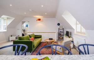 a living room with a green couch and a table at Gad About in Woodbridge