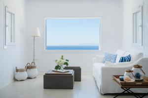 a living room with a white couch and a table at The Mykonian Escape in Mýkonos City