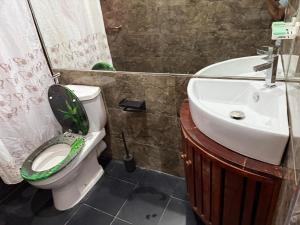a bathroom with a toilet and a sink at Perivale Budget Stay in Moratuwa