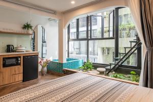 a large room with a kitchen and a large window at Hanoian Hearths - 5 Bedrooms - Bath Tubs - Projectors in Hanoi