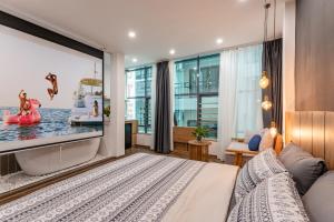 a bedroom with a large screen tv in a room at Hanoian Hearths - 5 Bedrooms - Bath Tubs - Projectors in Hanoi
