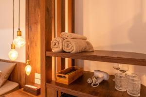 a room with a shelf with towels and glasses at Hanoian Hearths - 5 Bedrooms - Bath Tubs - Projectors in Hanoi