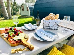 a picnic table with a basket of food and wine at Brora Escapes in Brora