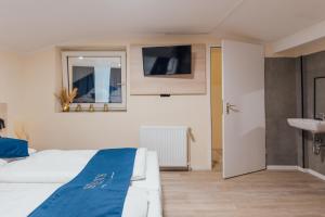 TV a/nebo společenská místnost v ubytování Steens Hotel Alster City