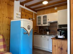 a kitchen with a blue refrigerator in a room at Horizon Nature - WIFI - Jardin in Jausiers +16 photos