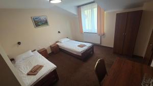 Pokój z 2 łóżkami, stołem i oknem w obiekcie Hotel-Restauracja-Bar Rudka w Ostrowcu Świętokrzyskim +18 zdjęć