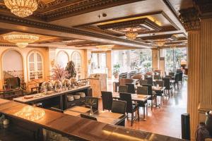a restaurant with a row of tables and chairs at Kangen Boutique Hotel in Yogyakarta +13 photos