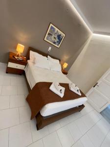 a bedroom with a bed with two towels on it at Dolphin Apt & Studios -Near the Beach in Roda
