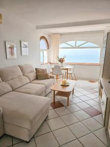 a living room with a couch and a table at The lighthouse horizon in Las Lagunas Mijas