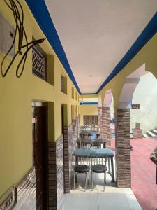 a patio with a table and chairs in a building at Hotel Abhinandan in Phata