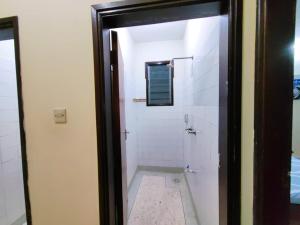 y baño blanco con ducha y espejo. en Terry Homes, en Mombasa