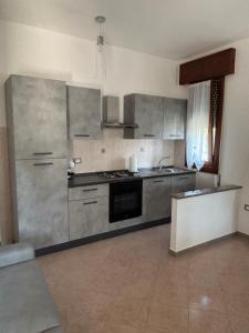 a kitchen with stainless steel appliances in a room at Casa Mari in Donzella