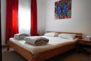 a bedroom with a bed with towels on it at Apartments Krnjic in Umag