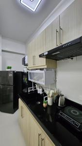a kitchen with a black counter top and black appliances at Oceanside Escape in Panglao Bohol in Panglao Island