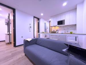 a living room with a couch and a kitchen at San Francisco Central Suites 2 rooms in Santa Cruz de Tenerife