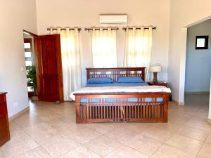 a bedroom with a bed with blue pillows at Villa Casa Modelo in Marbella +7 photos