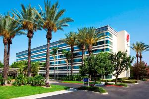 a building with palm trees in front of it at Sheraton Ontario Airport Hotel in Ontario