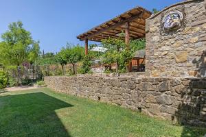 a stone building with a stone wall and a stone wall at Casa Serena, Radda In Chianti in Radda in Chianti