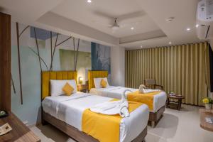 Postel nebo postele na pokoji v ubytování Hotel Classique, Rajkot