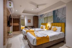 Postel nebo postele na pokoji v ubytování Hotel Classique, Rajkot