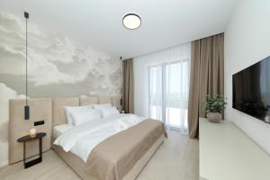 a bedroom with a large bed and a tv at Cloud 9 D5 in Tkon +42 photos