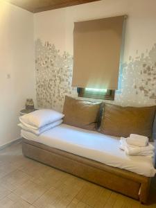 a large bed in a room with avertisement at APARMENTS Elina in Potamiá