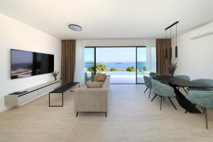 a living room with a tv and a table and chairs at Cloud 9 D6 in Tkon