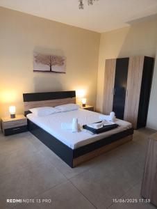a bedroom with a large bed and two night stands at Grand View Apartment in Panagia