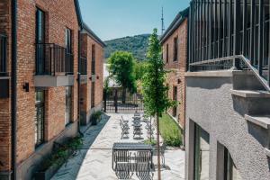 an alley with tables and chairs in between two buildings at Artifact Apart Hotel in Tbilisi City