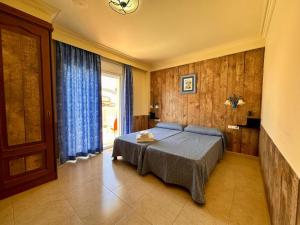 a bedroom with a bed and a large window at Hotel Portofino in Empuriabrava +34 photos